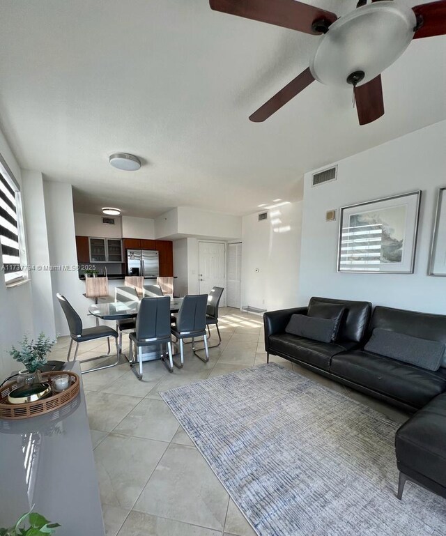 living room featuring light tile patterned floors and ceiling fan