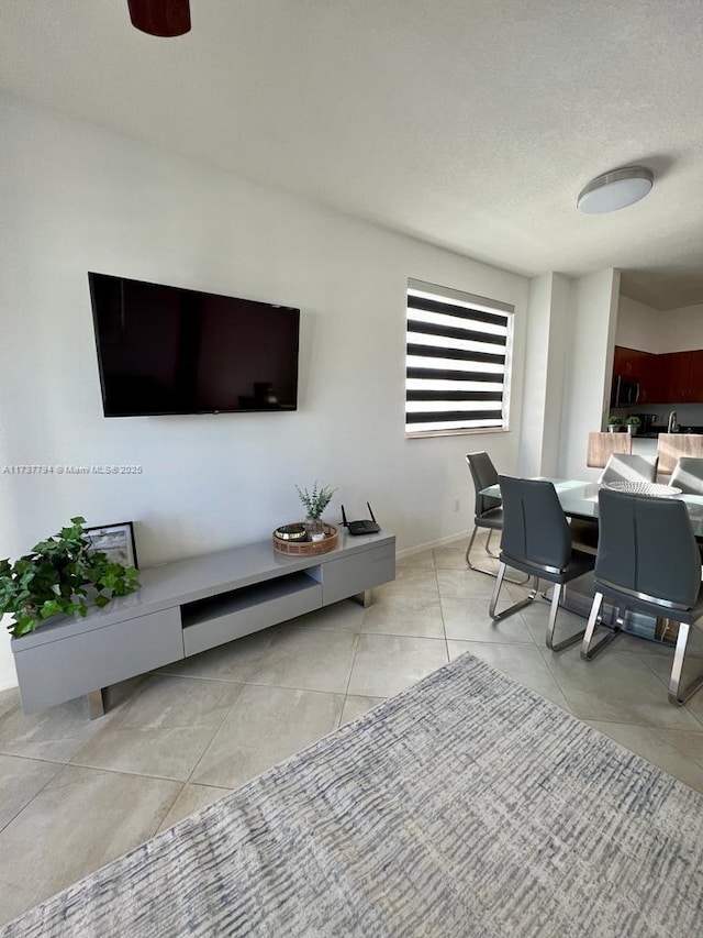 tiled living room featuring a textured ceiling