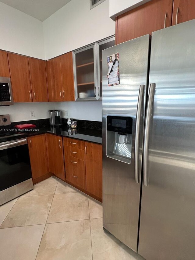 kitchen with stainless steel appliances and light tile patterned floors