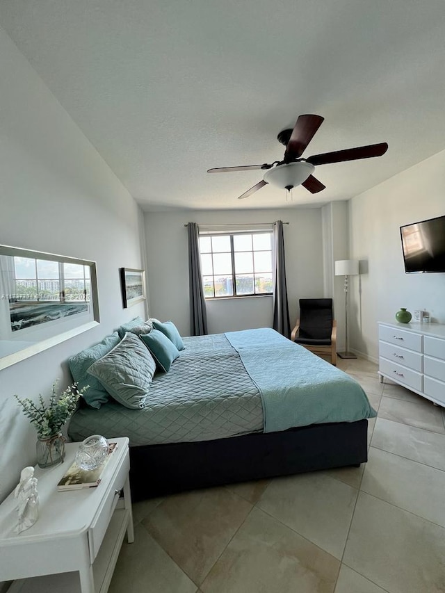 bedroom featuring ceiling fan and light tile patterned flooring