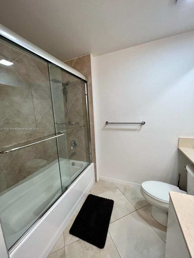 full bathroom featuring toilet, tile patterned floors, vanity, and shower / bath combination with glass door