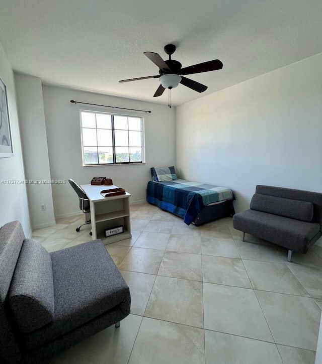 tiled bedroom featuring ceiling fan