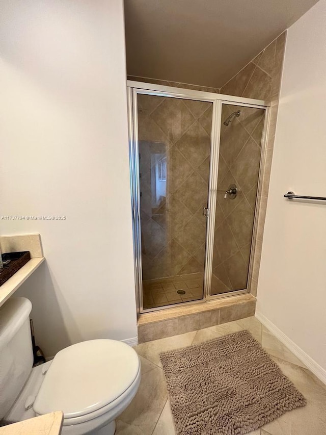 bathroom with walk in shower, tile patterned floors, and toilet