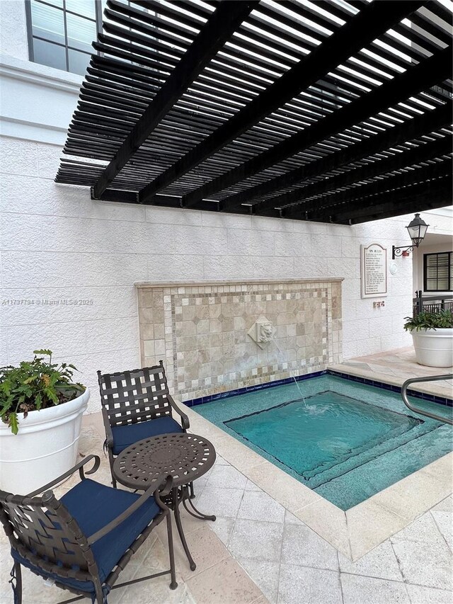 view of swimming pool with a patio and a pergola