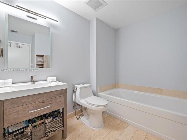 full bath featuring toilet, vanity, a garden tub, and visible vents