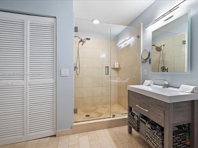 bathroom featuring a stall shower, a closet, and vanity