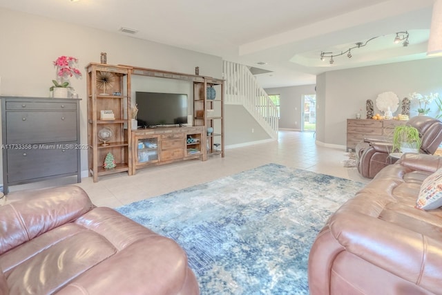 living room with light tile patterned floors and track lighting