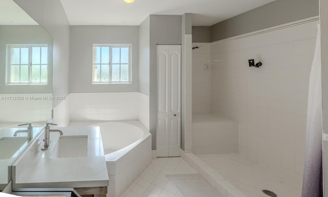 bathroom with a healthy amount of sunlight, shower with separate bathtub, and tile patterned flooring