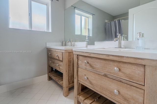 bathroom with vanity, curtained shower, tile patterned floors, and a healthy amount of sunlight