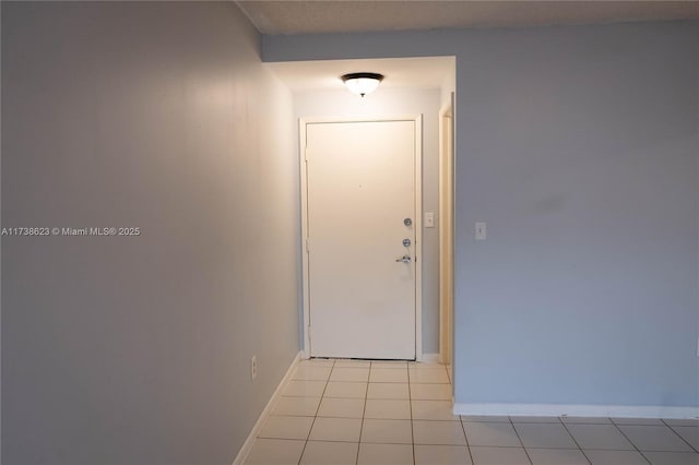 doorway with light tile patterned floors