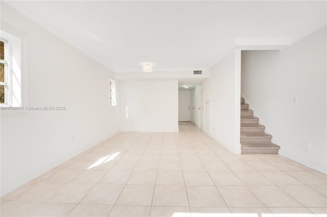 tiled empty room with crown molding