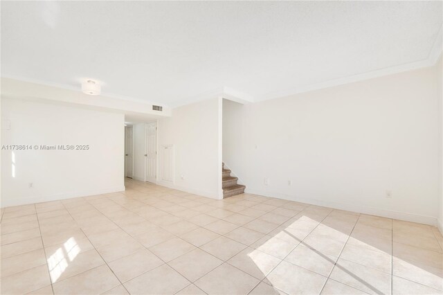 tiled empty room with crown molding