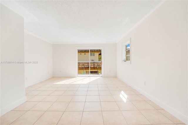 empty room featuring light tile patterned flooring, crown molding, and a textured ceiling