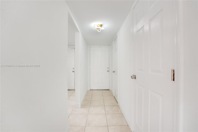 hall with light tile patterned floors