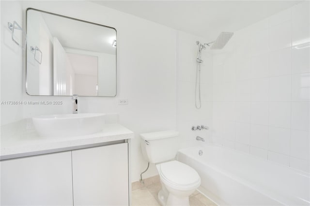 full bathroom with tiled shower / bath combo, vanity, tile patterned floors, and toilet