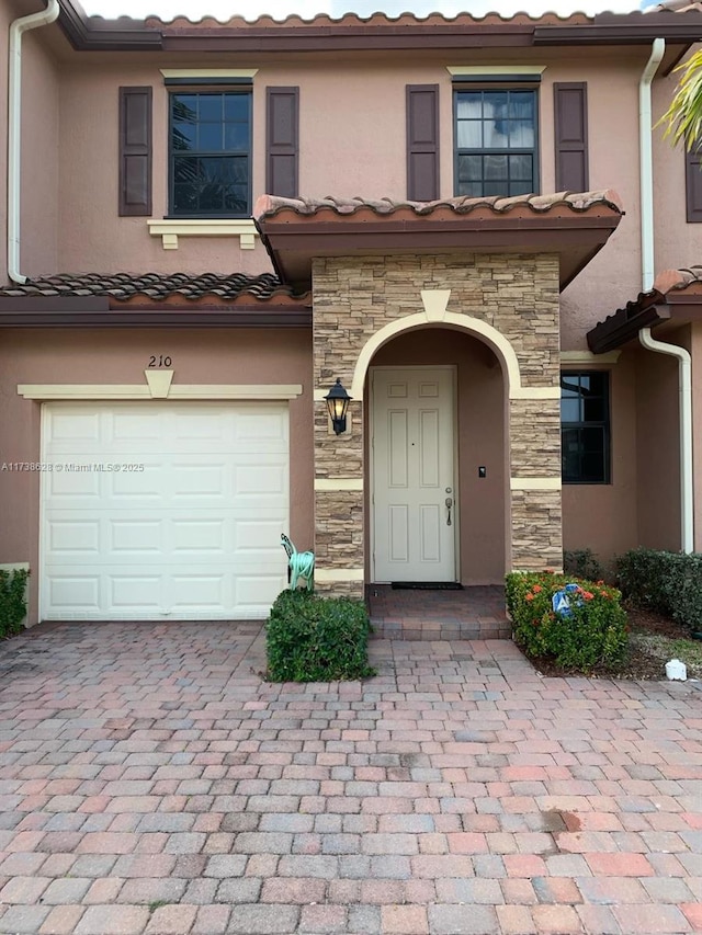 view of exterior entry with a garage