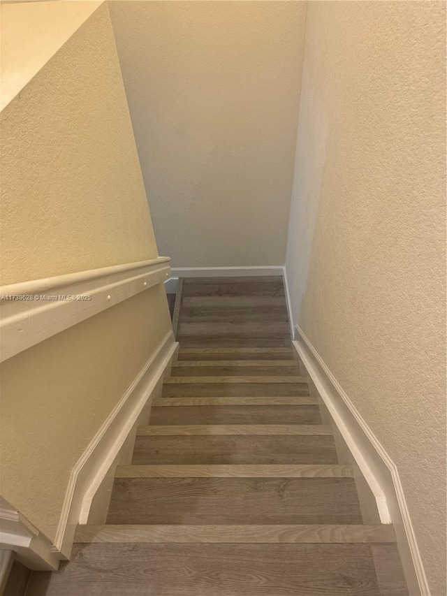 stairs with wood-type flooring