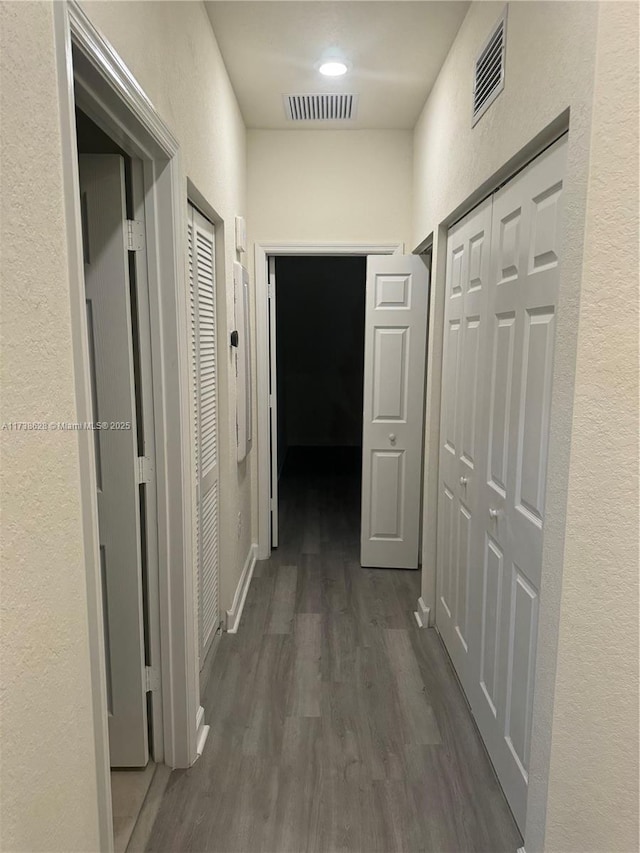 corridor with dark hardwood / wood-style floors