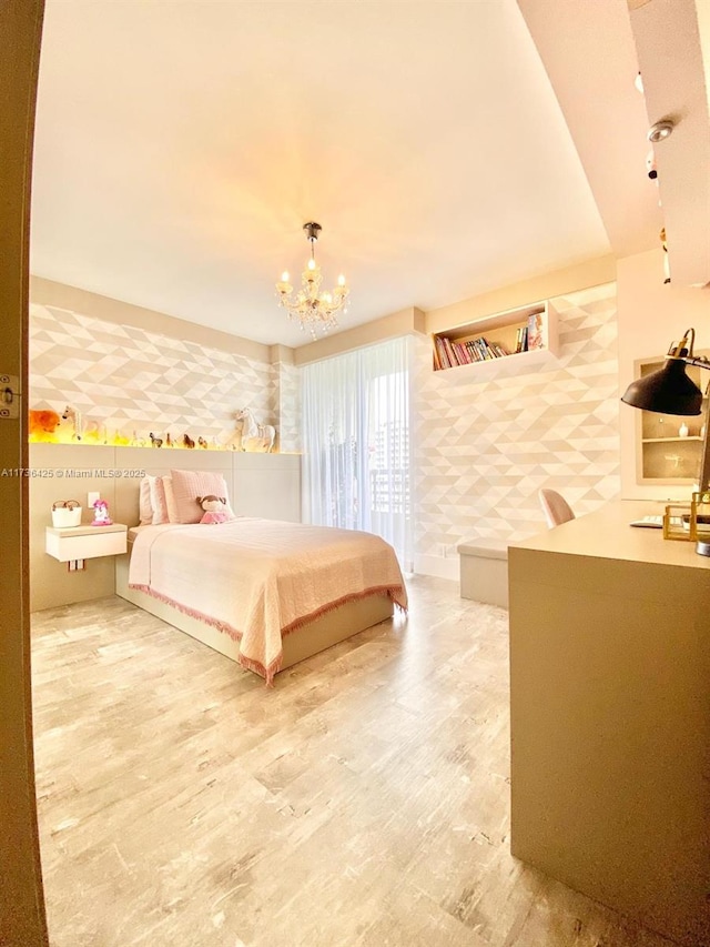 bedroom featuring wood-type flooring and a notable chandelier