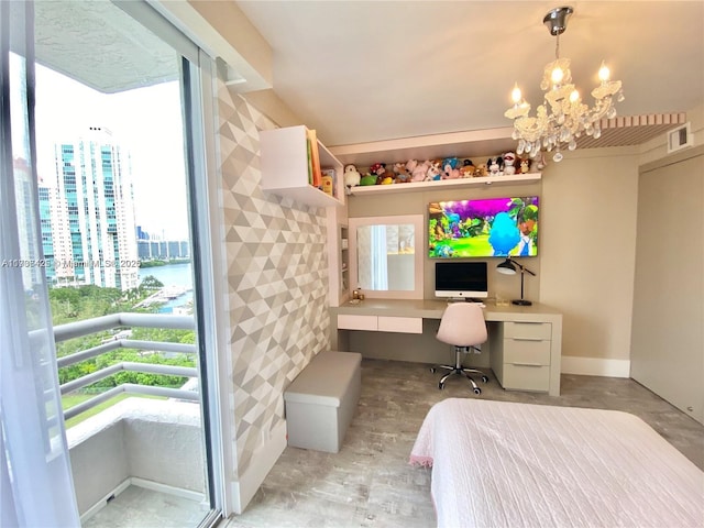 bedroom featuring built in desk and a chandelier