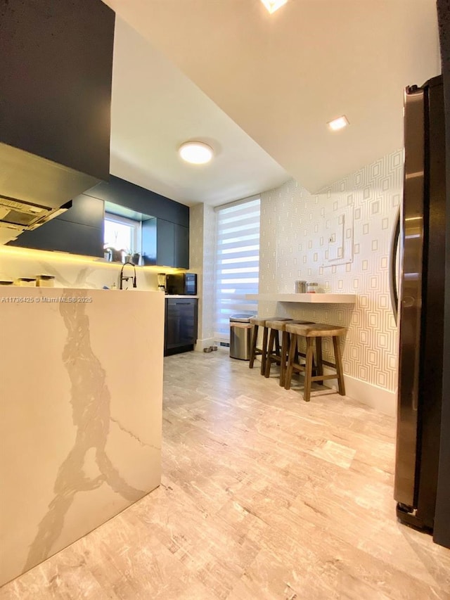 kitchen with sink and stainless steel fridge