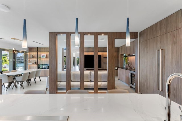 interior space with wine cooler and wooden walls