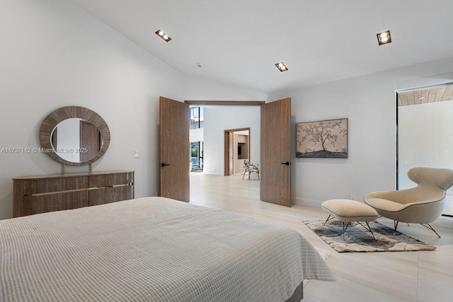 bedroom with high vaulted ceiling, light wood finished floors, and a closet