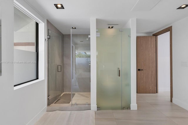 full bathroom featuring a stall shower and baseboards