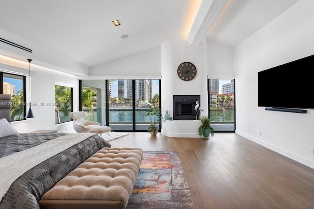 bedroom featuring baseboards, a fireplace with raised hearth, wood finished floors, access to outside, and high vaulted ceiling