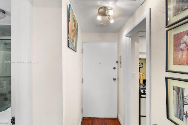 hallway with dark hardwood / wood-style floors