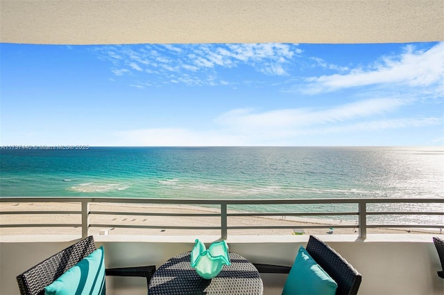 balcony with a beach view and a water view