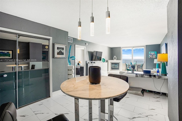 dining space with a textured ceiling