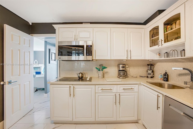 kitchen featuring white cabinetry, appliances with stainless steel finishes, sink, and backsplash