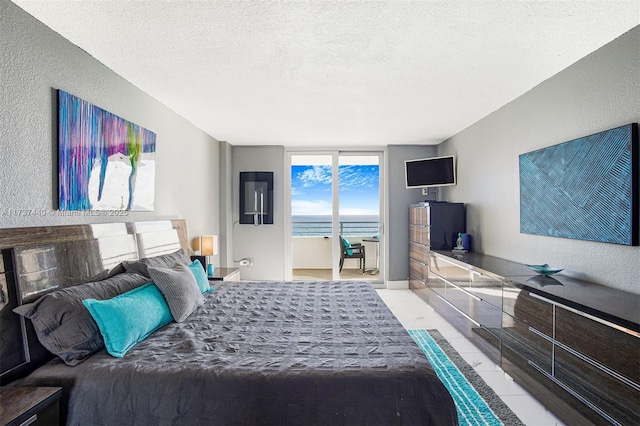 bedroom featuring access to outside and a textured ceiling