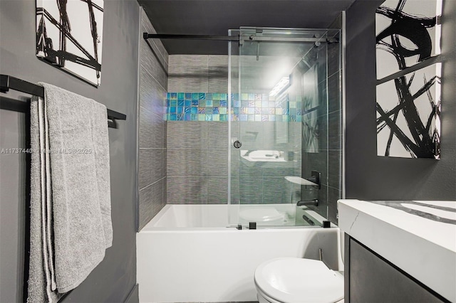 full bathroom with toilet, vanity, and bath / shower combo with glass door