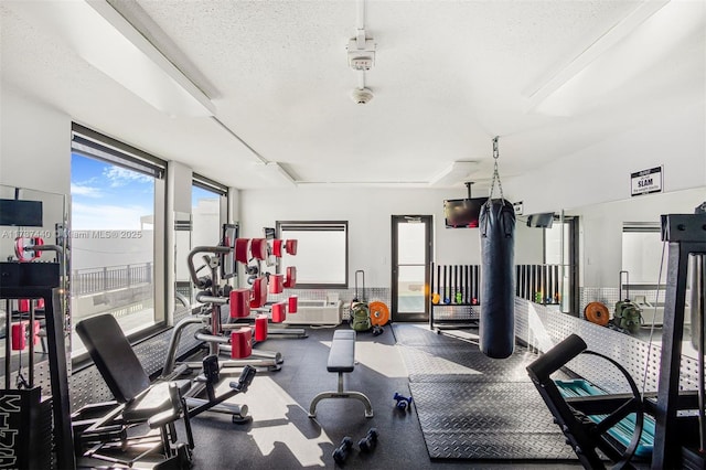 exercise room with a textured ceiling