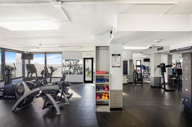 gym featuring a textured ceiling