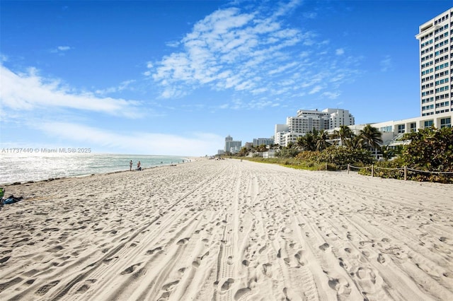 view of home's community with a water view and a view of the beach