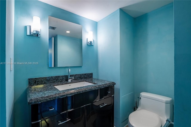 bathroom with vanity and toilet