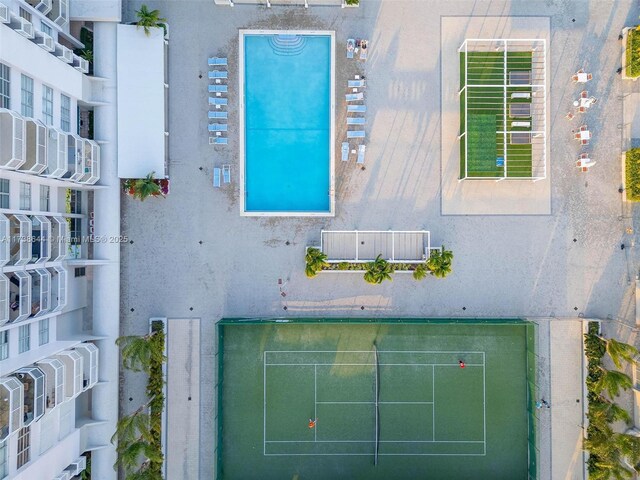 view of swimming pool featuring a water view and a patio area