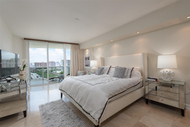 bedroom featuring light tile patterned flooring, floor to ceiling windows, and access to exterior