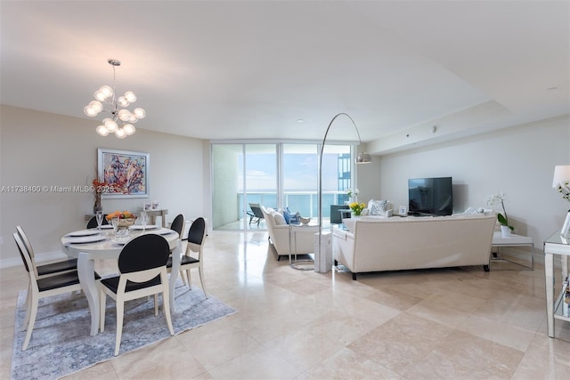 dining area with an inviting chandelier and a wall of windows