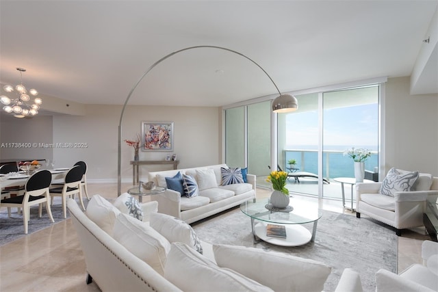 living room with an inviting chandelier, floor to ceiling windows, and a water view