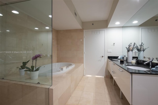 bathroom with vanity, tile patterned floors, and tiled bath