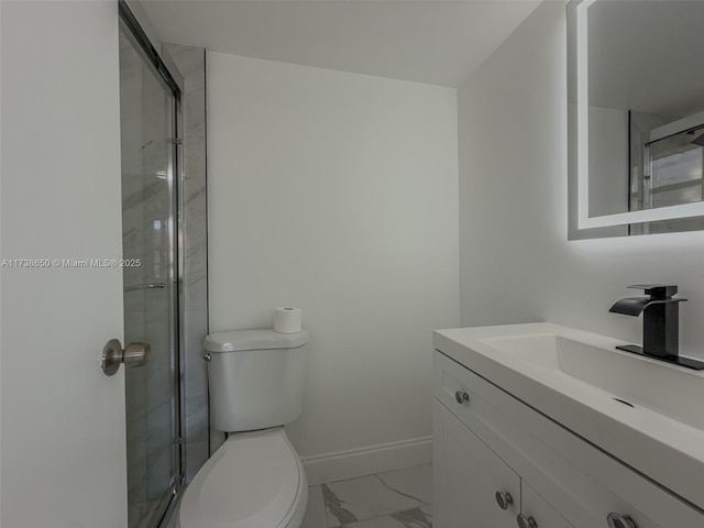 bathroom with vanity, a shower with shower door, and toilet