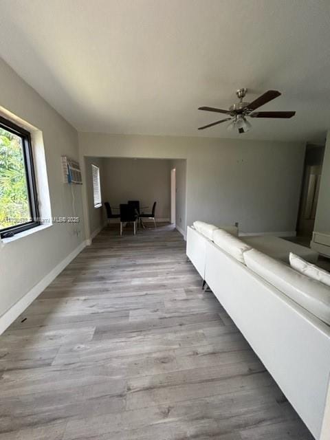 unfurnished living room featuring light hardwood / wood-style flooring and ceiling fan