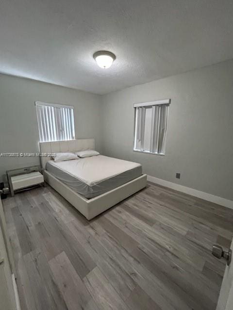 unfurnished bedroom featuring hardwood / wood-style flooring