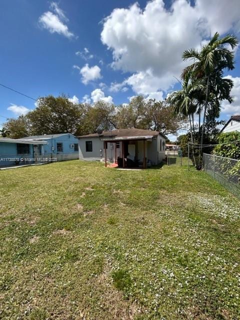 rear view of property with a yard