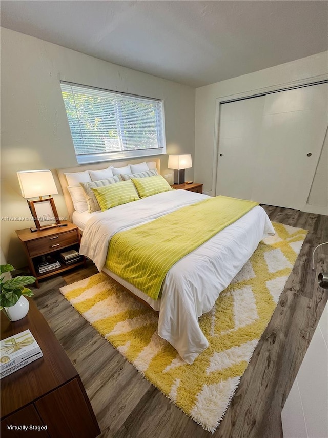 bedroom featuring dark hardwood / wood-style floors and a closet