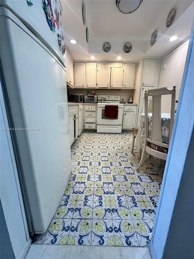 kitchen with white appliances and white cabinets